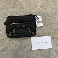 Nwt Authentic Balenciaga Wallet. Black With Rose Gold Hardware And Distressed Leather. Purchased From Barney’s New York. Bny Tag Accidentally Detached, But Is Included. Approximate Measurements: Length: 4.25” Width: 5.5” Luxury Wallets With Branded Hardware For Everyday Use, Luxury Wallets With Branded Hardware, Designer Wallet With Removable Pouch For Everyday Use, Designer Leather Coin Purse For Daily Use, Designer Black Leather Coin Purse, Designer Black Coin Purse For Everyday Use, Designer Black Clutch With Zipper Closure, Designer Black Coin Purse With Interior Card Slots, Designer Black Coin Purse With Card Slots