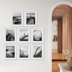 a living room with pictures hanging on the wall