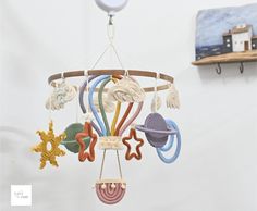 a wind chime hanging from the ceiling in a child's room with toys on it