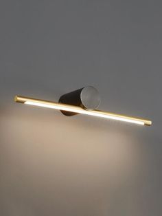 a light that is on the side of a wall with it's lights turned on