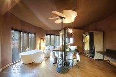 a large bathroom with wooden floors and walls