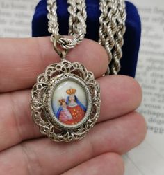 A beautiful genuine vintage hand-painted enamel Jesus & Mother Mary pendant, filigree religious charm on a chain, catholic holy charm, Jesus necklace medal, in fair used condition. Ideal for protection necklace, would make a nice gift for someone special! Comes with a nice approx 17 inch long 925 silver vintage necklace (see photo 3)! Material: solid silver, enamel Measures: approx 30 mm (1.2 inch) in diameter Box on photos is NOT included! A stunning religious jewelry shop well worth a visi Jesus Necklace, Glass Locket, Lapis Lazuli Ring, Protection Necklace, Photo Locket, Silver Lockets, Religious Jewelry, Vintage Necklace, Gold Pendant