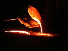 an orange liquid being poured into a bowl