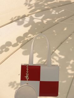 Editor's NotesChess square bag has a structural silhouette and tote handle. The compact size and simple design give a great point to your outlooks.- Square shape mini tote bag- White and red point check pattern- Slim silhouette bag with detachable round pouch- Front logo engraving and inner logo label- Inner open pocketsMeasurements(in.)- Size: One Size- Body width*height*depth: 7.1 * 5.7 * 1.6 in- Handle length: 13.4 inComposition & Care- Shell: 100% Sheep skin- Lining: 65% Poly, 35% Cotton Modern White Box Bag With Handles, White Double Handle Box Bag Gift, White Double Handle Box Bag For Gift, Daily Use Square Box Bag With Detachable Handle, Square Box Bag With Top Carry Handle, White Modern Handheld Box Bag, Modern White Handheld Box Bag, Red Square Box Bag With Top Handle, Red Square Box Bag With Top Carry Handle