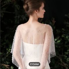 the back of a woman's wedding dress with pearls on it