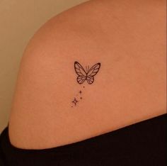 a small butterfly tattoo on the back of a woman's upper arm and shoulder