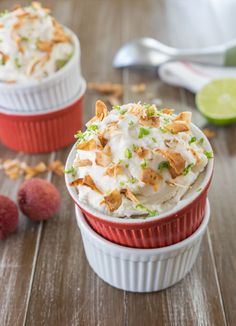 two cups filled with ice cream on top of a wooden table