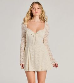 Let this romantic lace mini dress do all the talking at the school dance or as the lovely bride-to-be! The sheer long sleeves and flared cuffs add a touch of elegance, while the sweetheart neckline with bow tie highlights your feminine charm. With its flattering A-line silhouette and mini-length hem, this dress is perfect for any dressy occasion. Complete the look with earrings and a clutch purse.Fit & FeaturesLace fabric lined with stretchy knitSheer long sleeves with flare cuffsSweetheart neckline, bow tieA-Line silhouetteRuns true to size Homecoming Dresses Long Sleeve, Short Long Sleeve Dress, Lana Concert, Concert Fit, Hoco Dress, Lovely Bride, Free People Mini Dress, December Birthday, School Dance