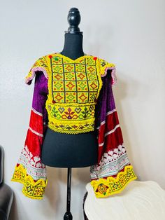 Item#CT1 Country of Origin: Afghanistan  Design: inspired by Afghan traditional dress Size:  Waist: 35 inches Chest: 35 inches Shoulder: 17 inches  Sleeves: 24 inches  This is an amazing Afghan Choli Crop Top, with vintage Beads in front. This top is Inspired by Afghan Clothing, and is an Handmade Banjara with amazing Color. You can wear it for Festivals, parties and events. Bohemian Multicolor Traditional Wear For Festivals, Multicolor Bohemian Traditional Wear For Festivals, Multicolor Ceremonial Choli For Festive Occasions, Festive Ceremonial Multicolor Choli, Festive Multicolor Ceremonial Choli, Bohemian Multicolor Traditional Wear For Ceremonies, Bohemian Multicolor Choli For Ceremonial Occasions, Bohemian Choli With Multicolor Embroidery For Festivals, Bohemian Traditional Wear With Multicolor Embroidery For Ceremonies