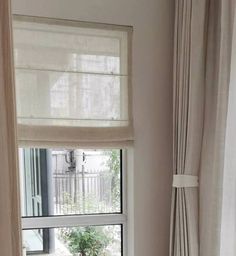 an open window in a room with white curtains