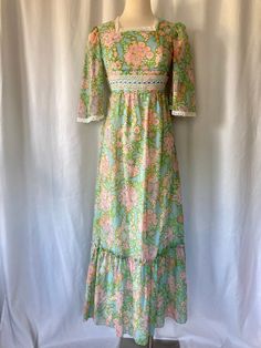 Sweet summery floral Maxi vintage 1970's 1980's Prairie blue with green, pink and purple flowers with green edges, tie back waist and lace trim, angel sleeves with ruffled bottom with back zipper.  Union Made in U.S.A Great vintage condition with no stains or rips  No tag size but best estimated size is XS/Small (4) Measurements (laying flat): Pit to Pit: 16" Waist: 13" Back Length: 55" Our items are vintage, older and/or pre-loved and may show signs of age. Items may have some imperfections, in 1960s Dresses, Angel Sleeves, Pink And Purple Flowers, Angel Sleeve, Prairie Dress, Blue And Pink, Floral Maxi, Dress Clothes For Women, Purple Flowers