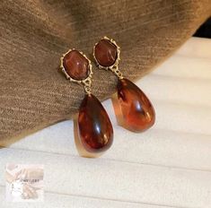 These retro brown drop earrings are the perfect blend of vintage charm and modern style. With their unique design and warm brown tones, they'll add a touch of nostalgia to any outfit. Brown Tones, Warm Brown, Vintage Charms, Jewelry Earrings Dangle, Modern Style, Piercings, Unique Design, United Kingdom, Dangle Drop Earrings