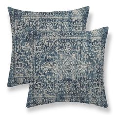 two blue and white pillows sitting on top of each other