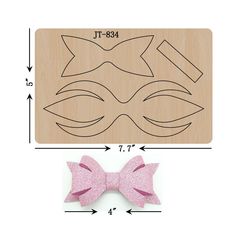 a wooden cutting board with a pink bow on it and a cut out of the face of a cat