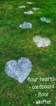 several white hearts painted on the grass