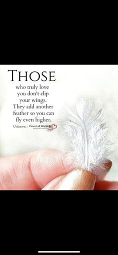 someone holding a feather in their hand with the quote those who truly love each other