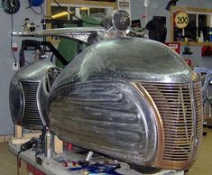 an old motorcycle being worked on in a shop