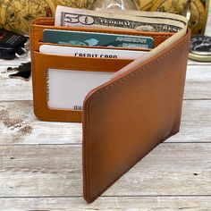 "The Wallet is made from highest quality Full-Grain Leather. It has 6 credit card slot, one slot for Driver License and has two billfolds to help your cash and receipt organized... It is Brown Color. There are Black, Dark Brown and Antic Brown Options The sizes are 4 1/2\" x 3 1/2\" x 3/8\" ( When it is empty) The open sizes are 9 \" x 3 1/2 \" x 3/16 \" It is made from Full-Grain Cowhide Leather The best way to avoid staining your wallet is to wipe everything away right when it gets on the leat Personalized Leather Gifts, Receipt Organization, Handwriting Gifts, Personalized Leather Wallet, Driver License, Engraved Wallet, Custom Wallet, Mens Wallet, Unique Gifts For Men