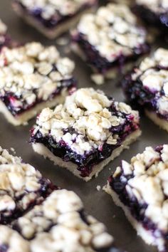 blueberry crumbles are arranged on top of each other in square pieces, ready to be eaten