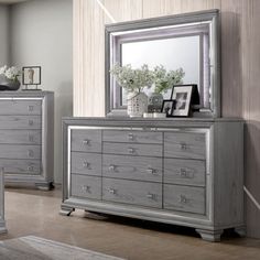 a bedroom scene with focus on the dresser and mirror, which is decorated in silver