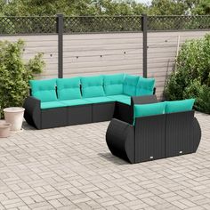 an outdoor patio furniture set with blue cushions and black wicker sofas on brick pavers