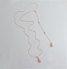 "CZ WEDDING BACKDROP NECKLACE This very elegant Lariat Back Necklace is perfect for that special occasion. This has a delicate a teardrop pendant that is surrounded by CZs in the front. Gorgeous! IT'S IN THE DETAILS ✦ Gold Filled, Rose Gold Filled or Sterling Silver Chain ✦ Shown at 26\" with an 6\" drop (No Clasp) ✦ Rose Gold or Silver Teardrop Shape CZ ✦ Shown with a 6\" drop ✦ Set of 2 includes: Necklace and Earrings ✦ Please note: No returns on wedding jewelry 🎁 To View Bridesmaids Gift, Cl Wedding Lariat Necklace With Cubic Zirconia And Adjustable Chain, Wedding Pendant Drop Necklace With Adjustable Chain, Gold Lariat Pendant Necklace For Wedding, Gold Pendant Lariat Necklace For Wedding, Rose Gold Clavicle Chain Necklace For Wedding, Adjustable Clavicle Chain Bridal Necklace For Wedding, Delicate Chain Pendant Drop Necklace For Wedding, Rose Gold Necklace With Adjustable Chain For Wedding, Rose Gold Necklaces With Adjustable Chain For Wedding