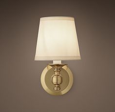 a wall light with a white shade on it