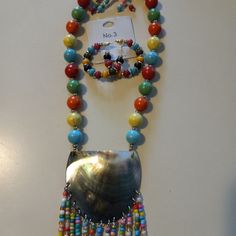 Single Strand 36" Beaded Necklace With Shell And 2 Pairs Of Coordinating Earrings. Very Bright Colors For Summer And Great Dress Up Or Down Piece. Very Fun & New From Market. Adjustable Multicolor Beaded Dangle Necklaces, Multicolor Dangle Jewelry For The Beach, Multicolor Dangle Jewelry For Beach, Colorful Dangle Jewelry For The Beach, Multicolor Adjustable Costume Jewelry Sets, Adjustable Multicolor Costume Jewelry Set, Beaded Dangle Jewelry, Beaded Dangle Jewelry Fashion Accessory, Adjustable Multicolor Dangle Jewelry