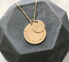 "You can personalize our Erin Necklace however you like but we love the combo of children's names on the large coin and couples initials on the petite round coin pendant. It's a perfectly complete family necklace set, hand stamped custom the way you like it. The pendants are thick and substantial, you'll feel their quality but the chains are light making it great for layering or everyday wear.   This listing includes: - one 7/8\" large 14k gold fill round pendant - hand stamped with any message up to a max of 18 characters including spaces and punctuation. Tiny heart stamp also available - one 1/2\" 14k gold fill round pendant, perfect for initials - hand stamped with up to a max of 4 characters including spaces, punctuation and heart stamp - your choice or 14k gold fill chain. Shown on .8 Small Gold Pendant, Glasses Holder Necklace, Layered Gold Necklace, Couples Initials, Necklace With Kids Names, Complete Family, Birthday Necklace Gift, 4 Characters, Gold Coin Necklace