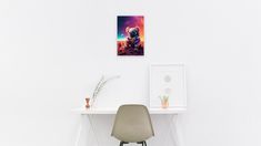 a chair sitting in front of a white desk with a painting on the wall above it