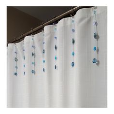 a shower curtain with blue beads hanging from it