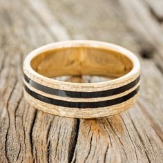 a wooden ring with black stripes on it