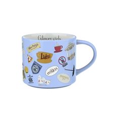 a blue coffee mug with various stickers on the inside and outside of it's handle