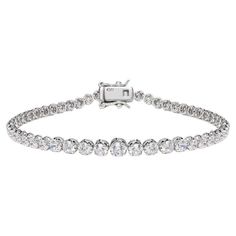 This dazzling claw set graduating round brilliant cut cubic zirconia tennis bracelet is a sparkling addition to any outfit. Featuring 4.56ct of round brilliant cut cubic zirconia set in 925 sterling silver with a high gloss white rhodium finish. Whether you're looking for a classic piece to add to your jewellery box, or something totally on-trend, designers Lustre of London believe that every woman should have the chance of owning exquisite designer jewelry, for that extra sparkle and glamour. L Silver Diamond Round Cut Tennis Bracelet, Luxury Adjustable Round Cut Tennis Bracelet, Luxury Silver Round Cut Tennis Bracelet, Luxury Cubic Zirconia Round Cut Tennis Bracelet, Luxury White Round Cut Tennis Bracelet, Bracelet Tennis, Antique Bracelets, Diamond Simulant, Tennis Bracelet Diamond