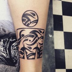 a black and white tattoo on the leg of a person