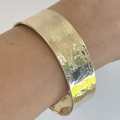 14KT polished yellow gold hammered + textured cuff bangle bracelet. An amazing. Italian-made, modern statement cuff to stack with more bangles. Open cuff; simply slide over wrist Fits most wrist sizes; adjustable size Width: 19mm 585/ 14kt purity Weight: 17g Made in Italy Luxury Stackable Bangle Cuff Bracelet, Luxury Modern Stackable Cuff Bracelet, Sterling Silver And Gold Hammered Cuff, Luxury Gold Artisan Cuff Bracelet, Luxury Yellow Gold Sterling Silver Bangle Bracelet, Luxury Hammered Bangle For Women, Luxury Hand Forged Yellow Gold Bracelets, Luxury Elegant Hammered Bangle, Luxury Handmade Brass Cuff Bracelet