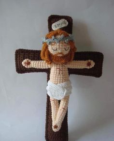 a crocheted jesus hanging from a cross