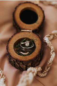 two wedding rings sitting in a wooden box