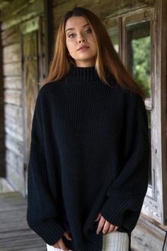 Hand knitted oversized silhouette womens sweater will suit you all year around. Garment is made of high quality yarns like merino wool & alpaca wool. Cosy plus size pullover sweater features a high neck, long puffy sleeves with ribbed details on the cuffs, two side splits delivers an effortless look which will match with your favourite jeans or skirt. Minimalist leather label brings a lovely handmade product touch. Natural wool yarns will keep you nice & cosy because it controls body tem Black Wool Sweater With Soft Knit, Oversized Wool Chunky Knit Sweater, Oversized Wool Sweater With Funnel Neck, Black Wool Oversized Sweater, Black Oversized Wool Sweater, Black Chunky Knit Turtleneck Sweater, Oversized Merino Wool Cable Knit Sweater, Oversized Merino Wool Knitted Sweater, Oversized Black Wool Sweater