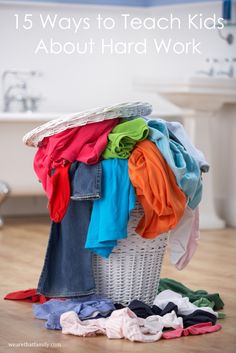 a laundry basket filled with clothes on top of a wooden floor