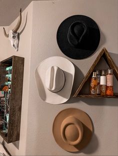 hats and other items are hanging on the wall in this room, including an antelope's head