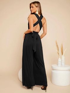 This Crisscross Tie Backless Plunging Neckline Jumpsuit is perfect for any formal or semi-formal event. The long length, high waist, and sleeveless features give it a sleek and stylish look. The deep V neckline and backless design add a touch of glam and sophistication to the look. The criss-cross ties at the back add a unique touch and make it stand out from the rest. Specifications: Color: Black Pattern Type: Plain Details: Backless, Criss Cross Length: Long Fit Type: Regular Fit Neckline: Deep V Neck Sleeve Length: Sleeveless Waist Line: High Waist Fabric: Medium Stretch Composition: 95% Viscose, 5% Elastane Care Instructions: Machine wash or professional dry clean Body: Unlined Sheer: No Size Chart(cm): Size Bust Hip Size Inseam Length Thigh Waist Size S 88 154 74.5 145 94.5 62 M 92 15 Comfy Jumpsuits, Clean Body, Black Pattern, Plunging Neckline, Long Length, Semi Formal, Formal Event, Criss Cross, Composition