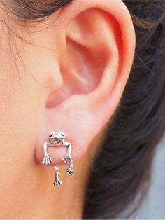 a woman's ear is shown with an animal charm on it