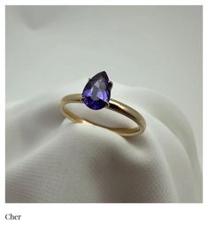 The Cher Ring (Solitaire) This ring was inspired by the one and only, Cher.  Just like it's namesake, it stands alone in all it's proud and unique beauty.  This deep and moody purple Sapphire, pear cut Solitaire radiates strength and indipendence. Product Info: Natural (Untreated) Genuine Violet Purple Sapphire  .84 Ct.  Pear Cut  Solitaire   2mm - 18K Gold Band SI Clairty Please note: All our Sapphire gemstones are genuine and natural, meaning they were mined from the earth and left untreated. Timeless Purple Rings Perfect For Gifts, Timeless Purple Rings As Gifts, Timeless Purple Rings For Gifts, Classic Purple Sapphire Ring With Prong Setting, Classic Purple Birthstone Ring, Classic Purple Round Band Ring, Classic Purple Solitaire Ring, Classic Purple Rings With Prong Setting, Classic Purple Sapphire Promise Ring