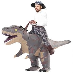 a man riding on top of an inflatable t - rexe wearing a pirate hat