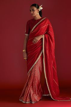 Red saree with all-over honeycomb foil prints, embellished borders, edged with kinari and crushed palla with gota work. Comes with paan-patti motif embroidered blouse piece.
Components: 2
Pattern: Embroidered, Foil Printed
Type Of Work: Paan-patti Motif, Honeycomb Patterns
Fabric: Raw Silk
Color: Red
Other Details: 
Note: Stitched blouse worn by the model is not for sale
Disclaimer: The actual print-placement and colour of the product may vary slightly from the image shown.
Occasion: Wedding - A Floral Print Sarees, Black Saree, Red Saree, Blouse For Women, Silk Organza, Party Wear Sarees, Saree With Blouse, Printed Sarees, Embroidered Silk