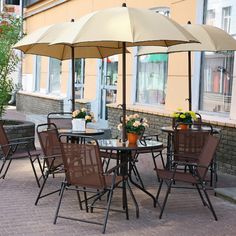 an outdoor dining set with umbrellas and chairs