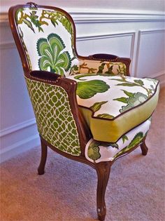 a green and white chair sitting on top of a carpeted floor next to a wall