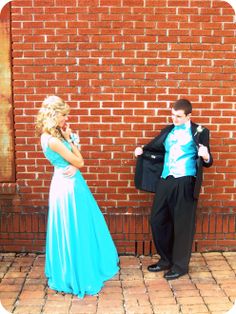 a man in a tuxedo standing next to a woman in a blue dress