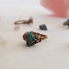 My wire wrapped crystal rings are the perfect accessory for any outfit. These genuine turquoise nuggets might be tiny, but they hold all the purification healing properties of any larger size turquoise stone such as dispelling negative energy and aligning your chakras. Steampunk meets boho chic; they resemble a robin's egg in a little nest. Mix and match and stack them with other rings to enhance their healing properties and personalize your style. The bands are twist braided by hand and the cry Wire Wrapped Turquoise, Kyanite Ring, Raw Turquoise, Wire Wrapped Crystal, Wrapped Crystal, Wire Wrapping Crystals, Moonstone Crystal, Midi Rings, Wire Wrapped Rings